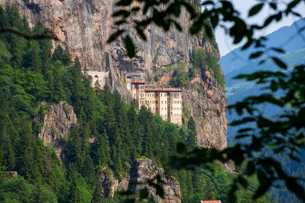 Close-up of the monastery's stacked stone facade and window openings on the cliff